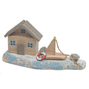 Wooden House & Sail Boat By The Sea Shore